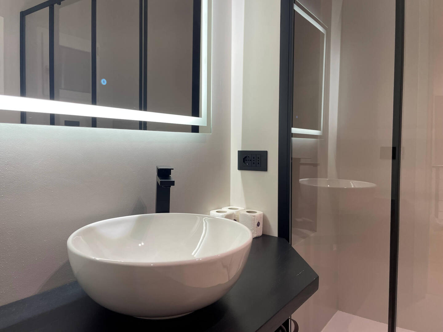 Bright, sleek, and spotless—a modern bathroom with quality fittings and a walk-in shower.